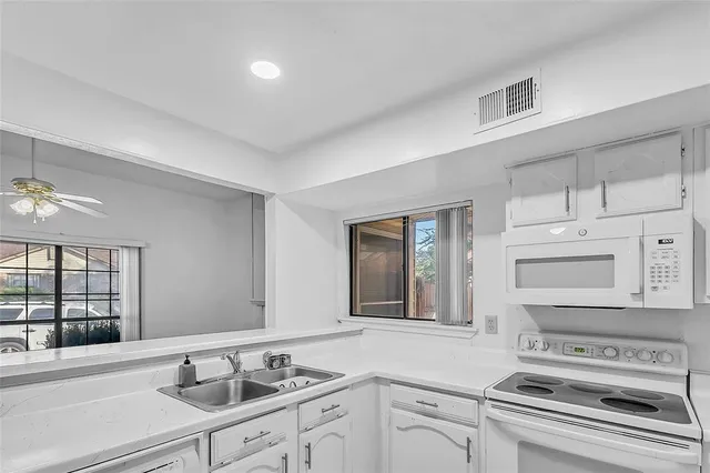 a kitchen with a sink cabinets and window