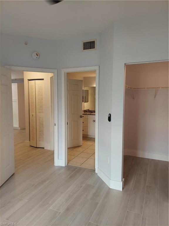 6341 Aragon Way, Unit 106 Fort Myers, FL 33966 - Photo 14 of 29 an empty room with wooden floor and windows