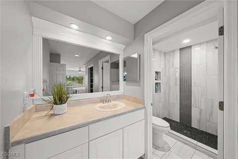 a bathroom with a double vanity sink toilet and shower