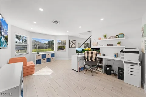 a work room with furniture and natural light