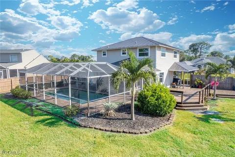 a view of a house with swimming pool and sitting area