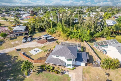 an aerial view of a house with a yard pool outdoor seating and yard