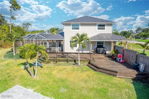 a view of a house with swimming pool and sitting area