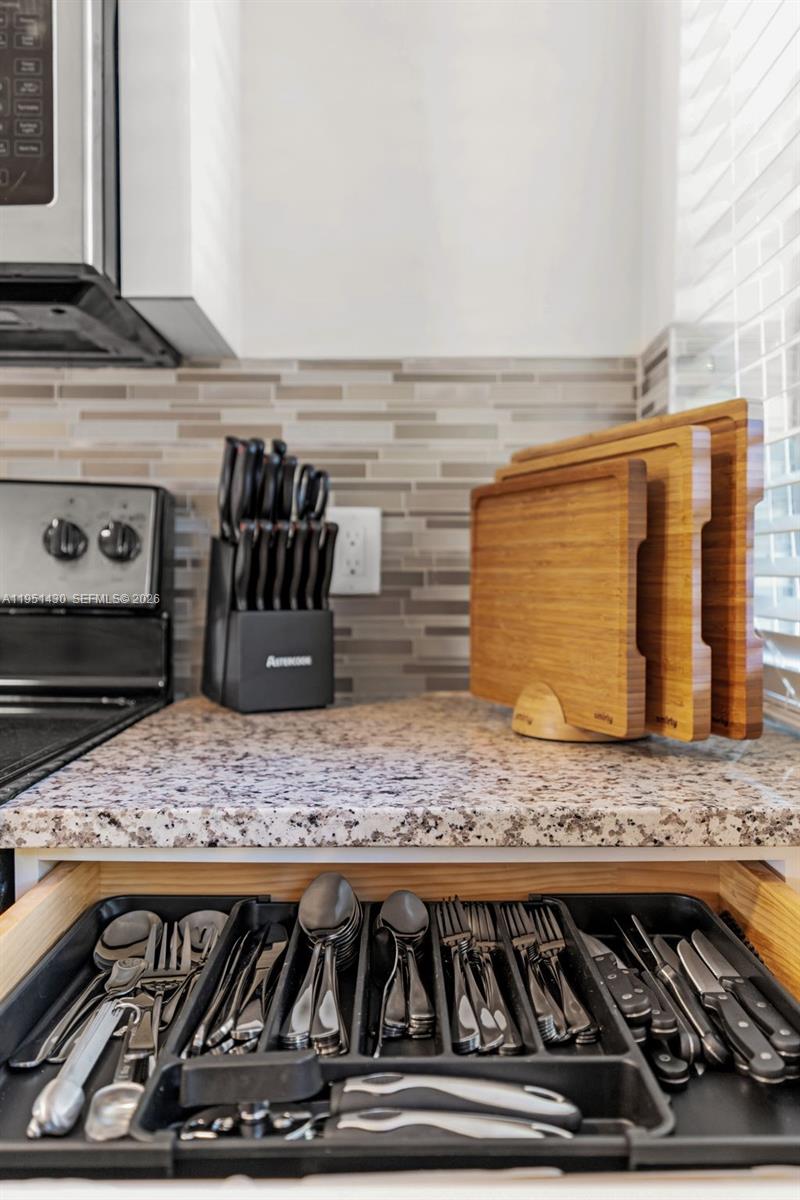 1075 Northeast 12th Avenue, Unit 1075 Homestead, FL 33033 - Photo 16 of 49 a kitchen with a stove and cabinets