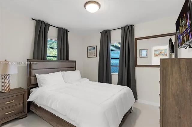 a bedroom with a bed and window