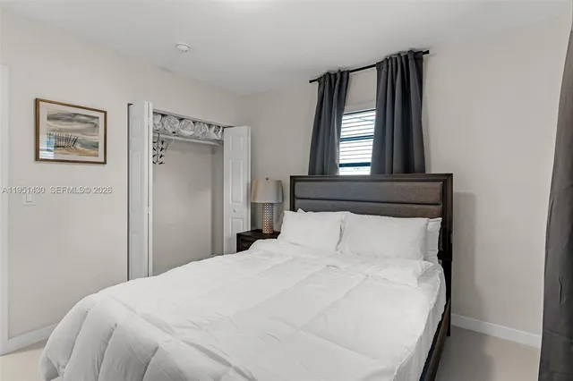 a bedroom with a bed and a cabinet