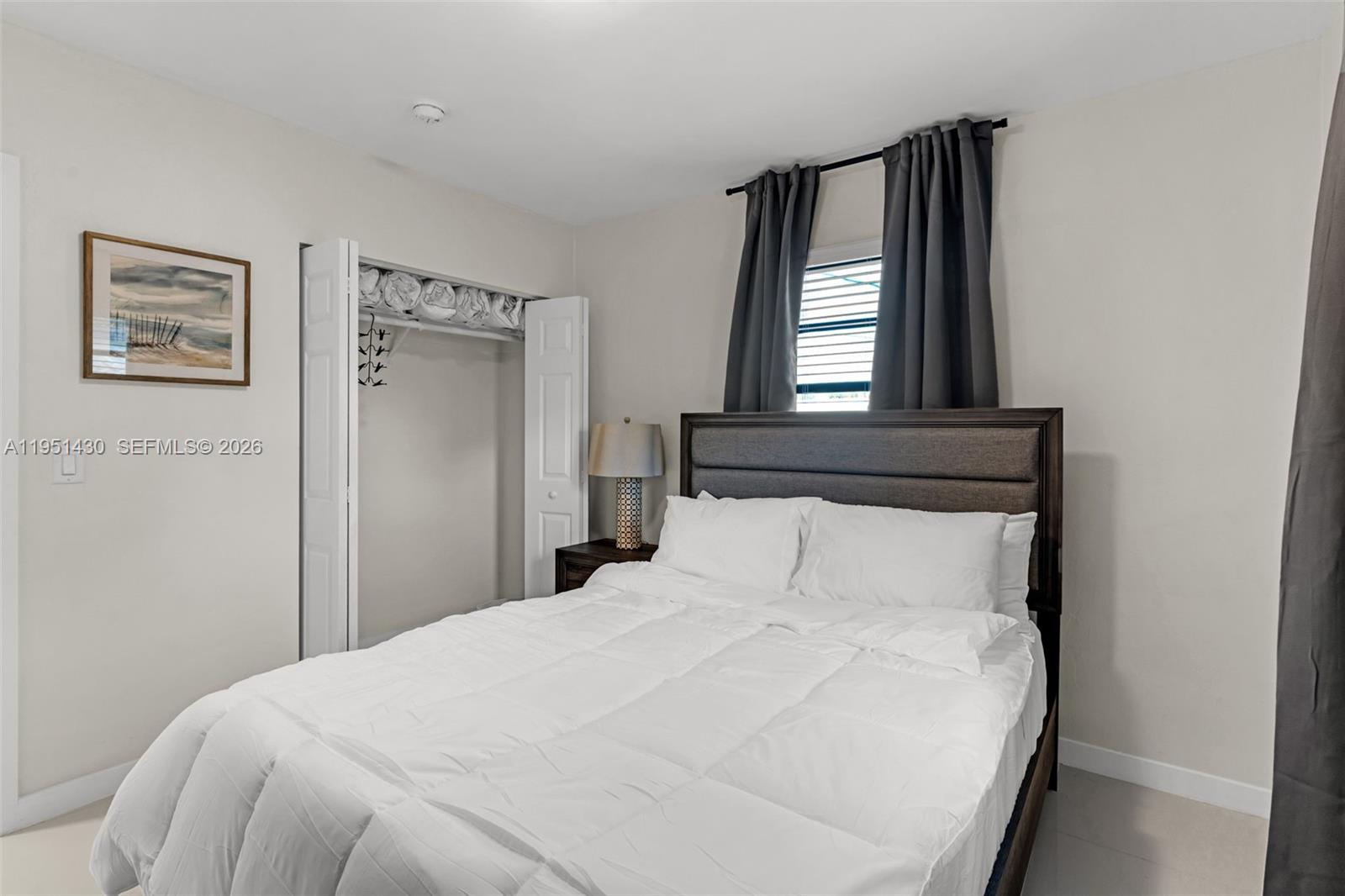 1075 Northeast 12th Avenue, Unit 1075 Homestead, FL 33033 - Photo 20 of 49 a bedroom with a bed and window