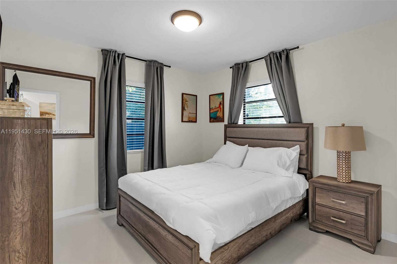 1075 Northeast 12th Avenue, Unit 1075 Homestead, FL 33033 - Photo 22 of 49 a bedroom with a bed and a window