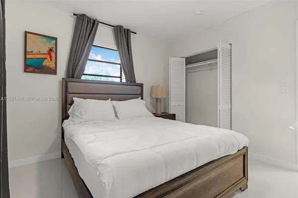 a large white bed in a white room