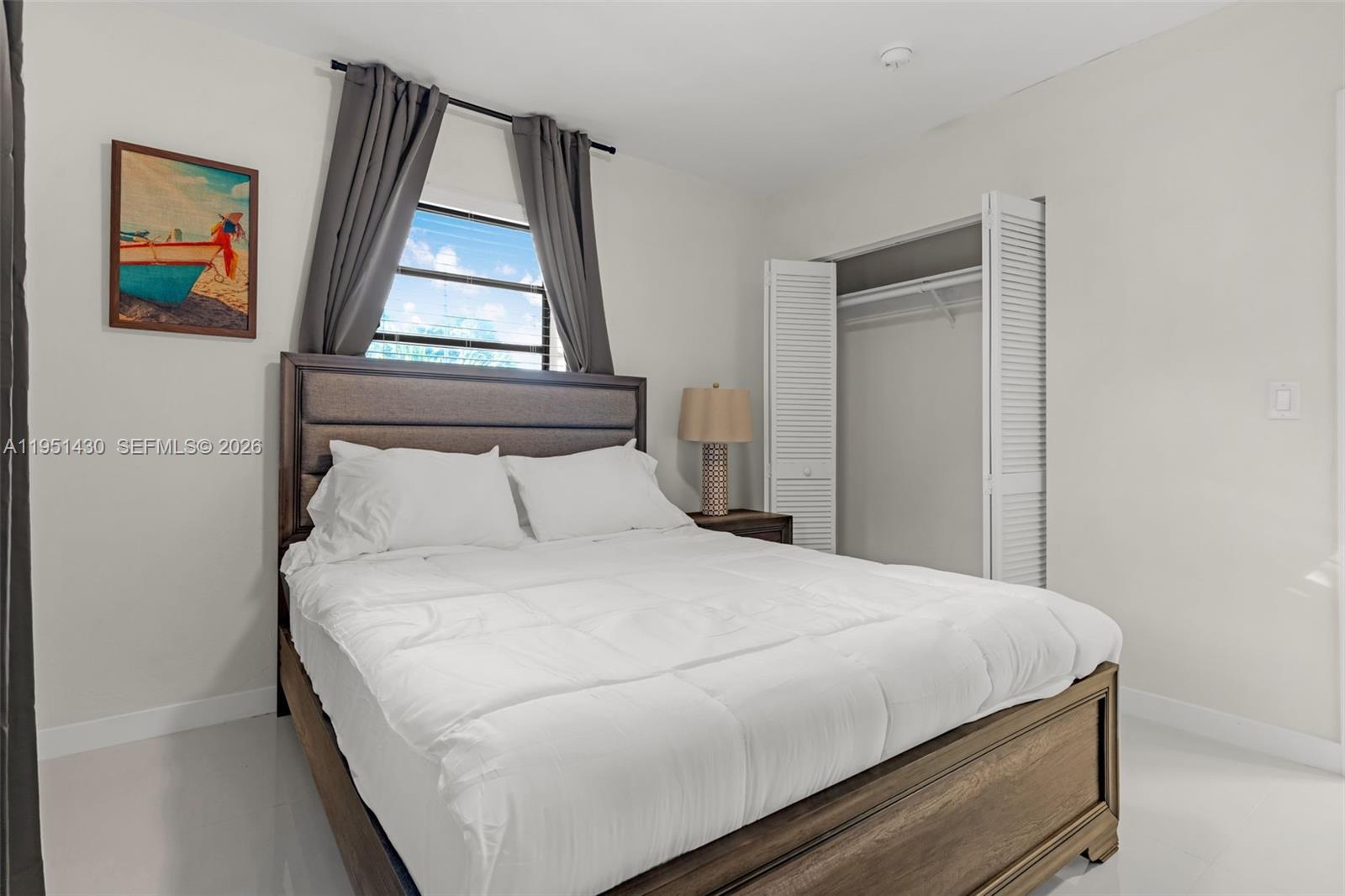 1075 Northeast 12th Avenue, Unit 1075 Homestead, FL 33033 - Photo 23 of 49 a bedroom with a bed and window