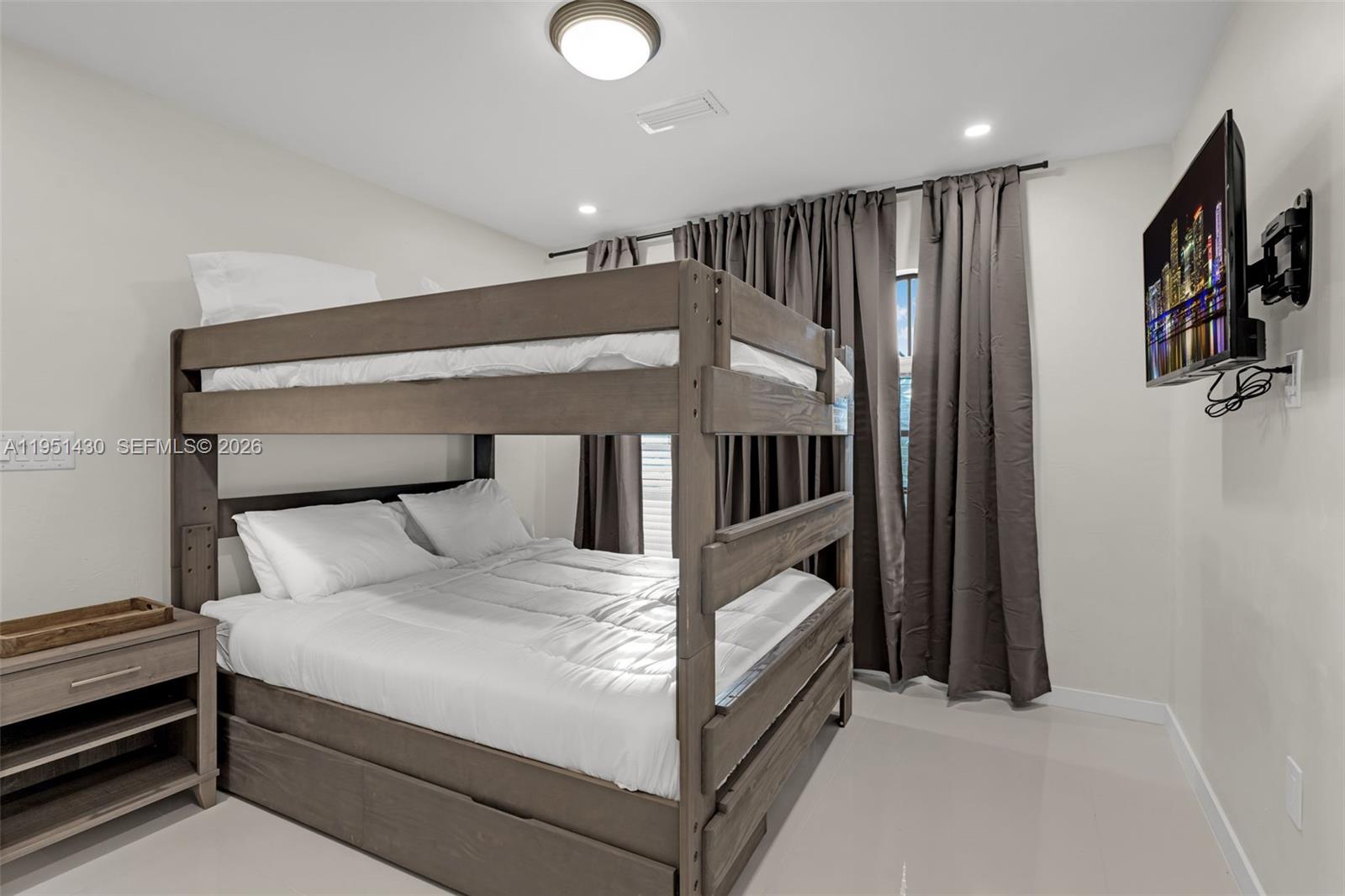 1075 Northeast 12th Avenue, Unit 1075 Homestead, FL 33033 - Photo 24 of 49 a large white bed in a white room