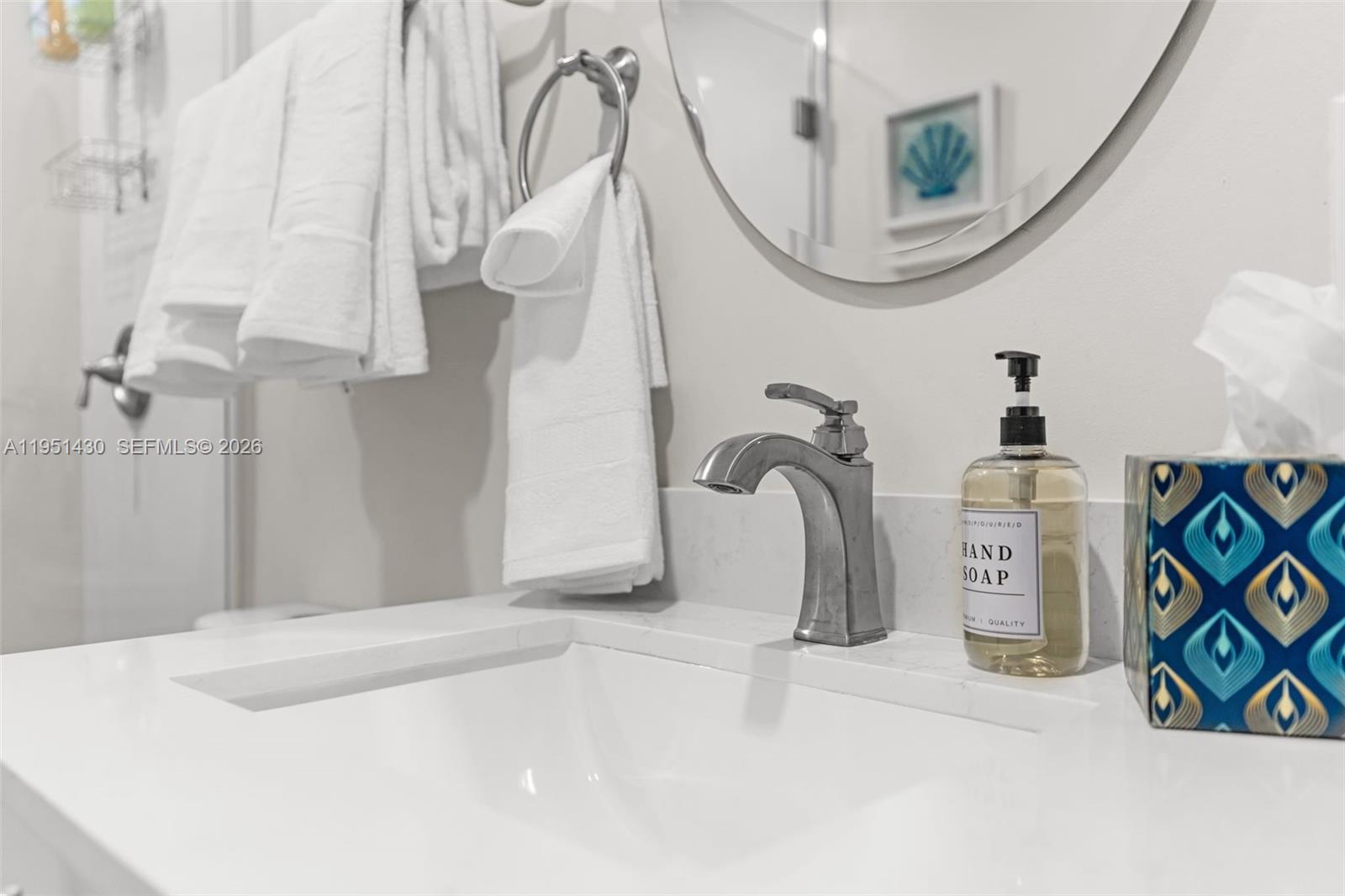 1075 Northeast 12th Avenue, Unit 1075 Homestead, FL 33033 - Photo 27 of 49 a bathroom with a sink a mirror and vanity