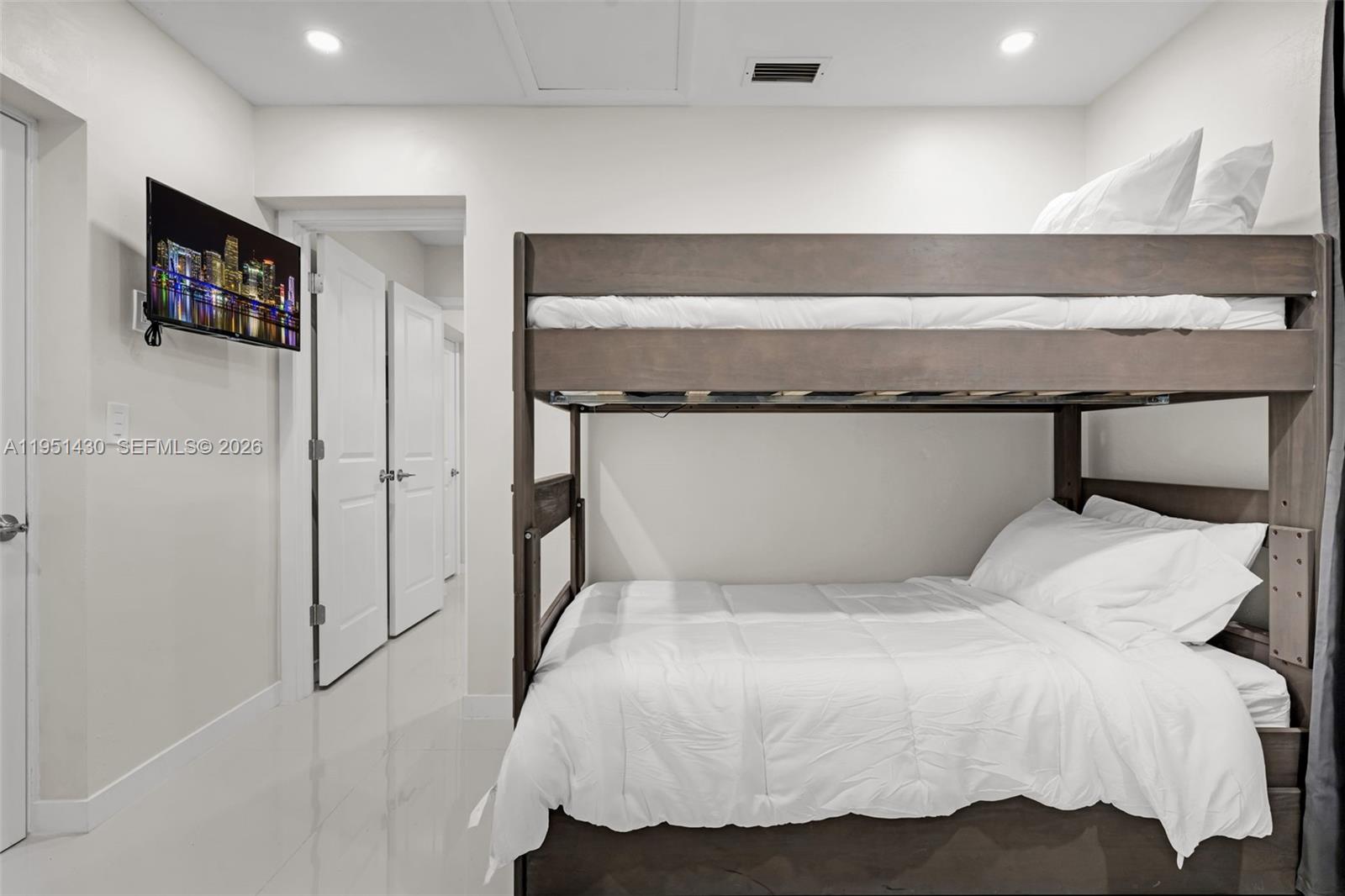 1075 Northeast 12th Avenue, Unit 1075 Homestead, FL 33033 - Photo 28 of 49 a bedroom with a bed and a flat screen tv