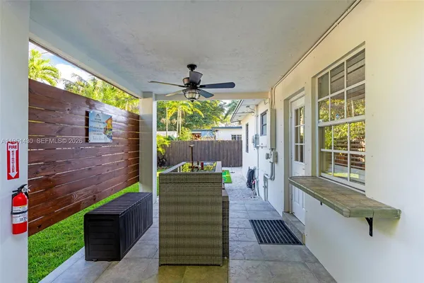 a small yard with plants and a trees in the background