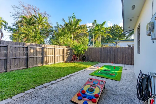 a backyard of a house with table and chairs