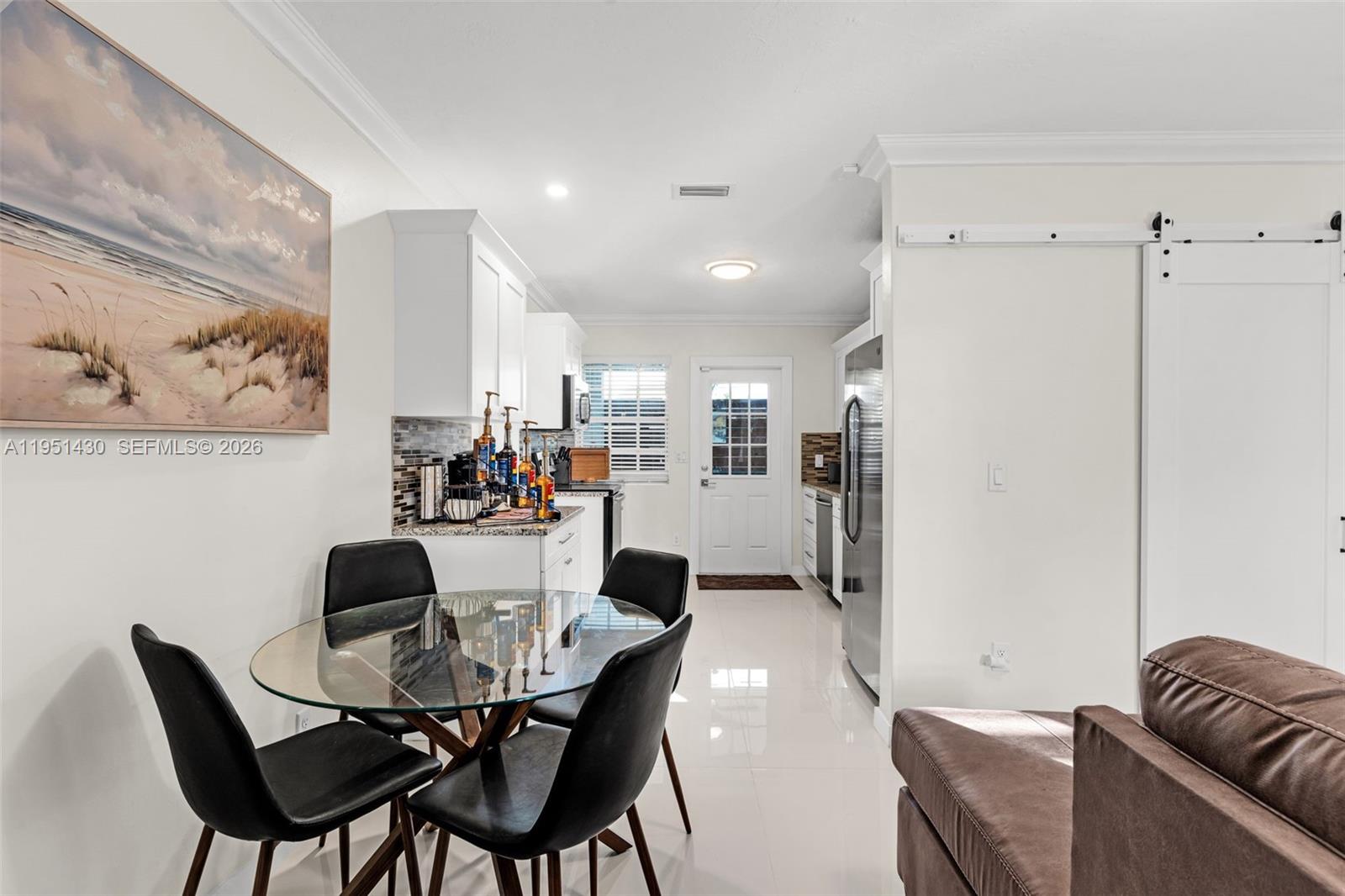 1075 Northeast 12th Avenue, Unit 1075 Homestead, FL 33033 - Photo 4 of 49 a view of a dining room with furniture