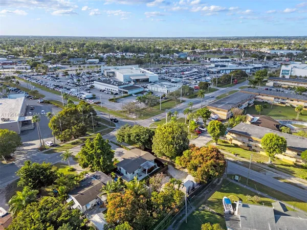 an aerial view of residential houses with city view