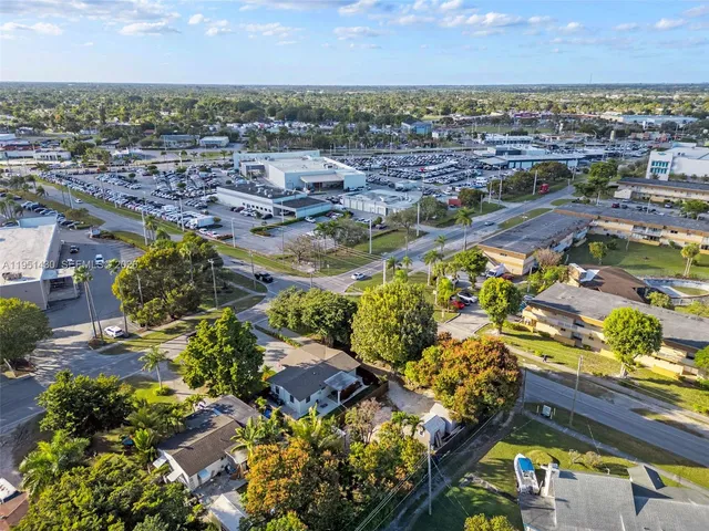 an aerial view of residential houses with city view