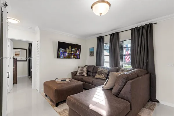 a living room with furniture and a large window