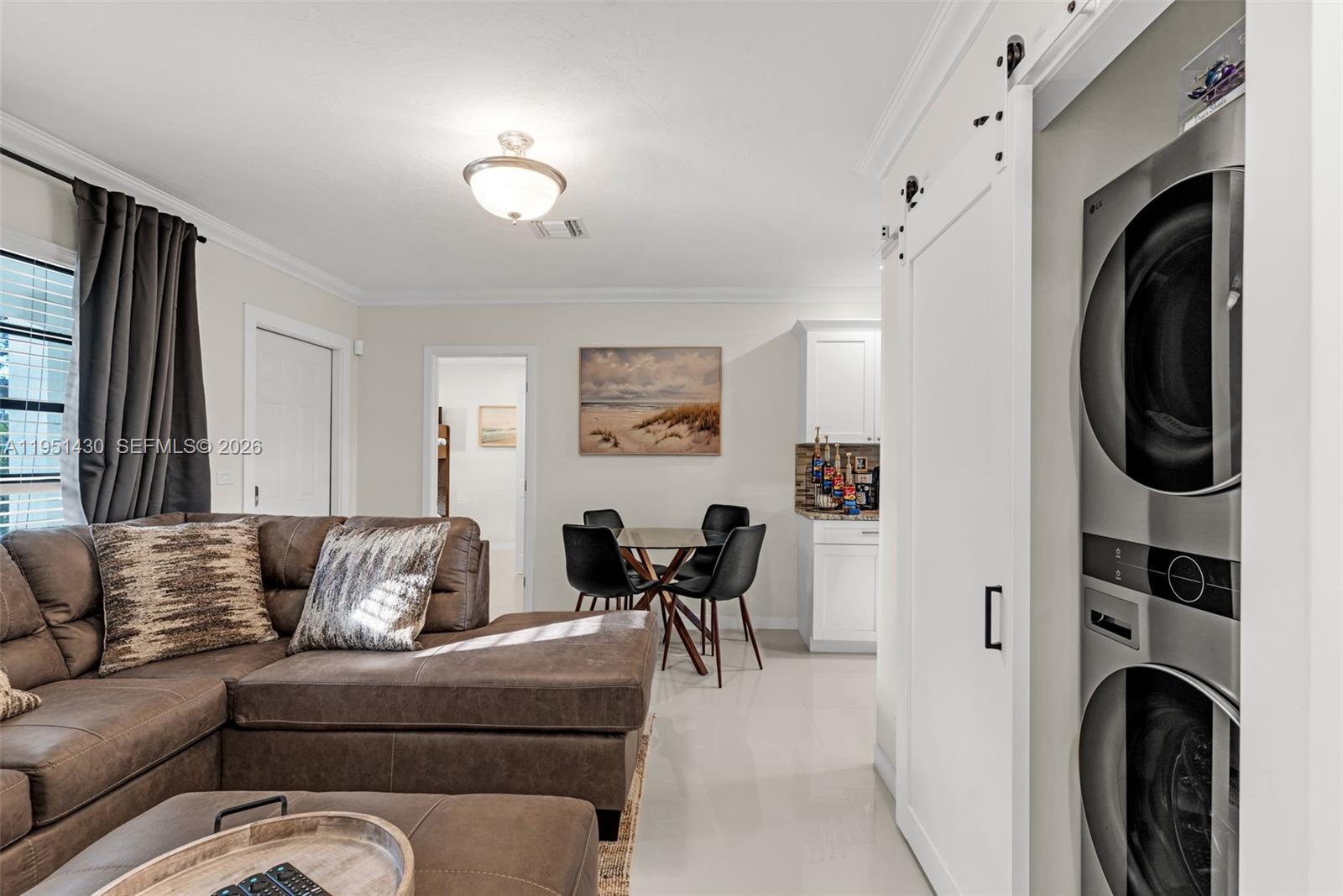 1075 Northeast 12th Avenue, Unit 1075 Homestead, FL 33033 - Photo 7 of 49 a living room with furniture a fireplace and a flat screen tv