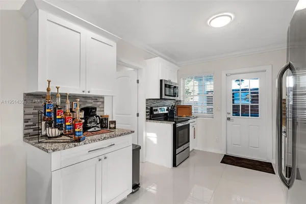 a kitchen with refrigerator and cabinets