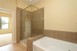 17040 West Fm 1097 Road, Unit 5103 Montgomery, TX 77356 - Photo 11 of 25 a bathroom with a bathtub and a shower
