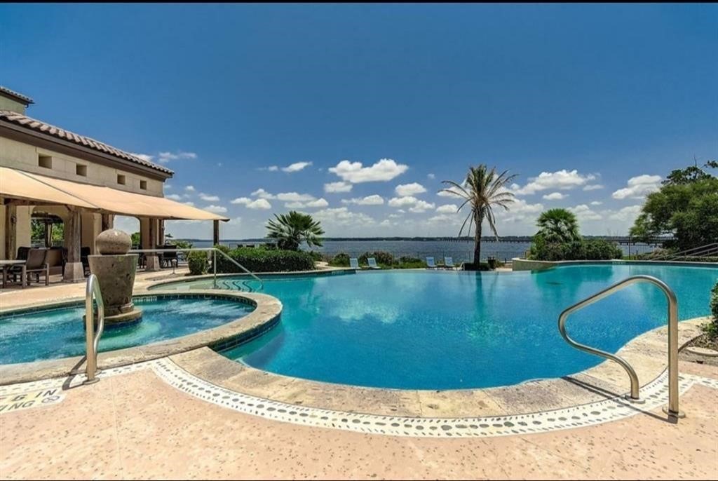 17040 West Fm 1097 Road, Unit 5103 Montgomery, TX 77356 - Photo 17 of 25 a view of a swimming pool with a fountain in the background
