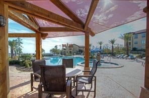 17040 West Fm 1097 Road, Unit 5103 Montgomery, TX 77356 - Photo 18 of 25 a view of a patio with chairs and table in the patio