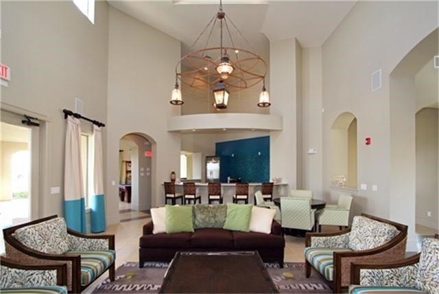 17040 West Fm 1097 Road, Unit 5103 Montgomery, TX 77356 - Photo 23 of 25 a living room with fireplace furniture and a chandelier