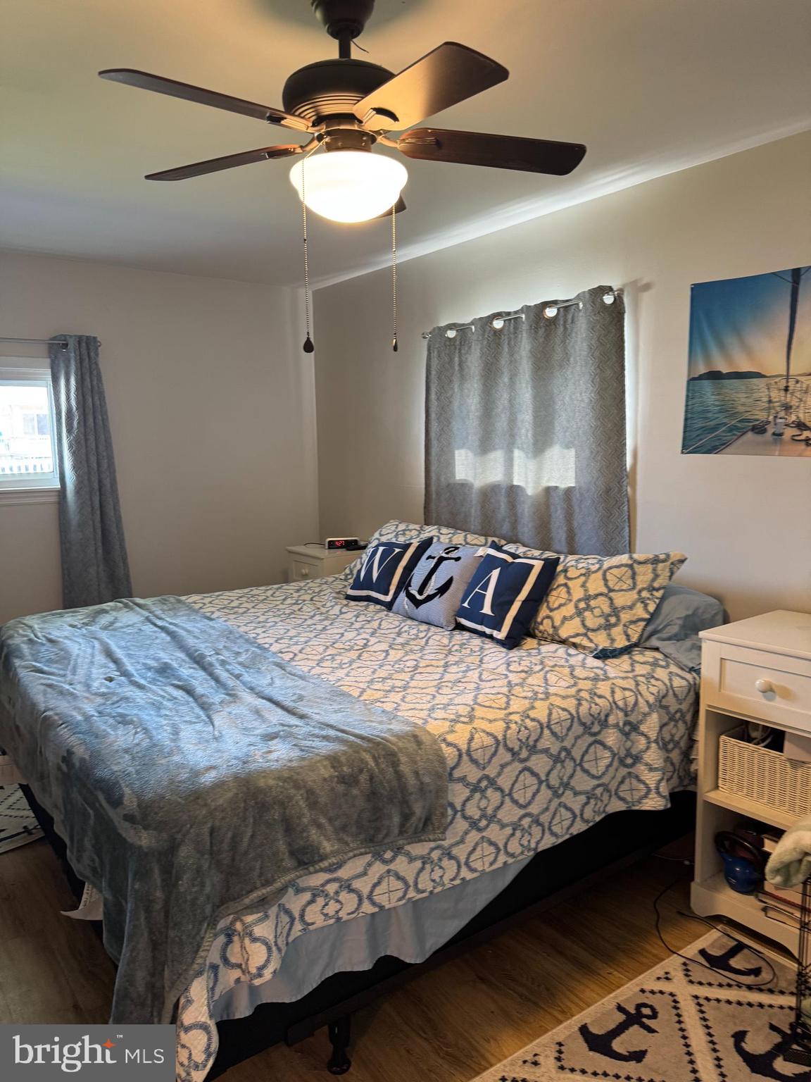 25 West Dory Drive Little Egg Harbor, NJ 08087 - Photo 10 of 56 a bedroom with a bed and a chandelier