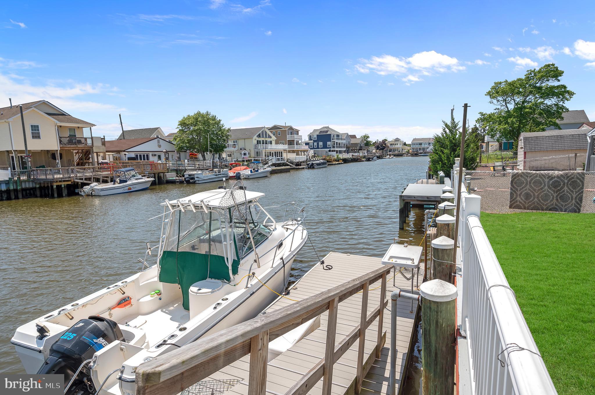 25 West Dory Drive Little Egg Harbor, NJ 08087 - Photo 24 of 56 a view of a lake with a house swimming pool and outdoor seating