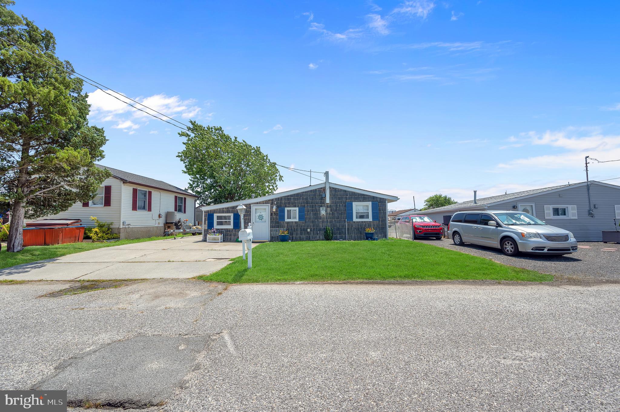 25 West Dory Drive Little Egg Harbor, NJ 08087 - Photo 43 of 56 a front view of a house with a yard and garage
