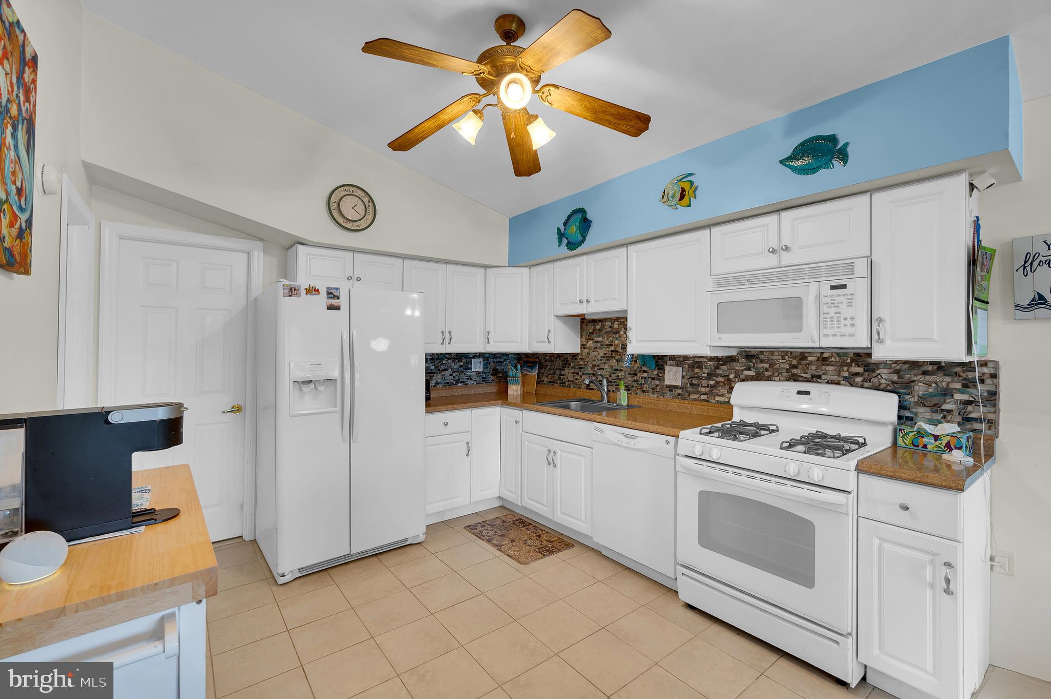 25 West Dory Drive Little Egg Harbor, NJ 08087 - Photo 46 of 56 a kitchen with stainless steel appliances white cabinets and a refrigerator