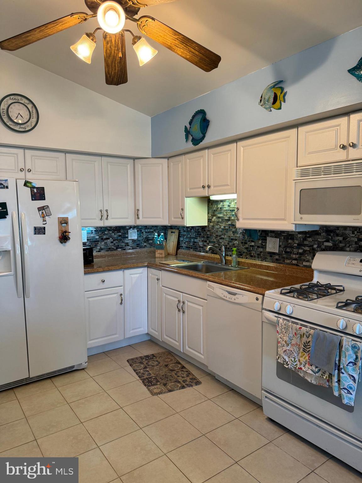 25 West Dory Drive Little Egg Harbor, NJ 08087 - Photo 4 of 56 a kitchen with a refrigerator a stove a microwave and cabinets