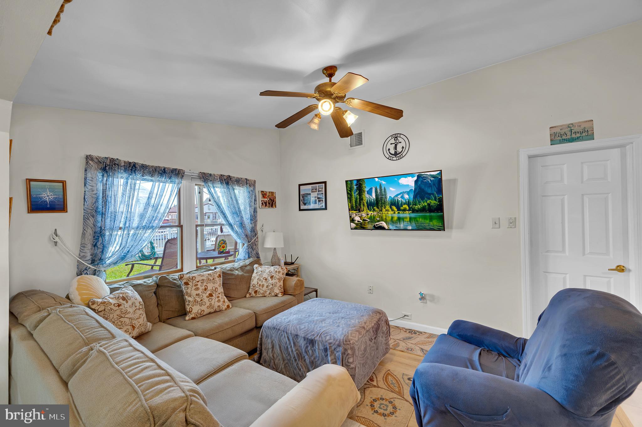 25 West Dory Drive Little Egg Harbor, NJ 08087 - Photo 50 of 56 a living room with furniture a large window and a flat screen tv