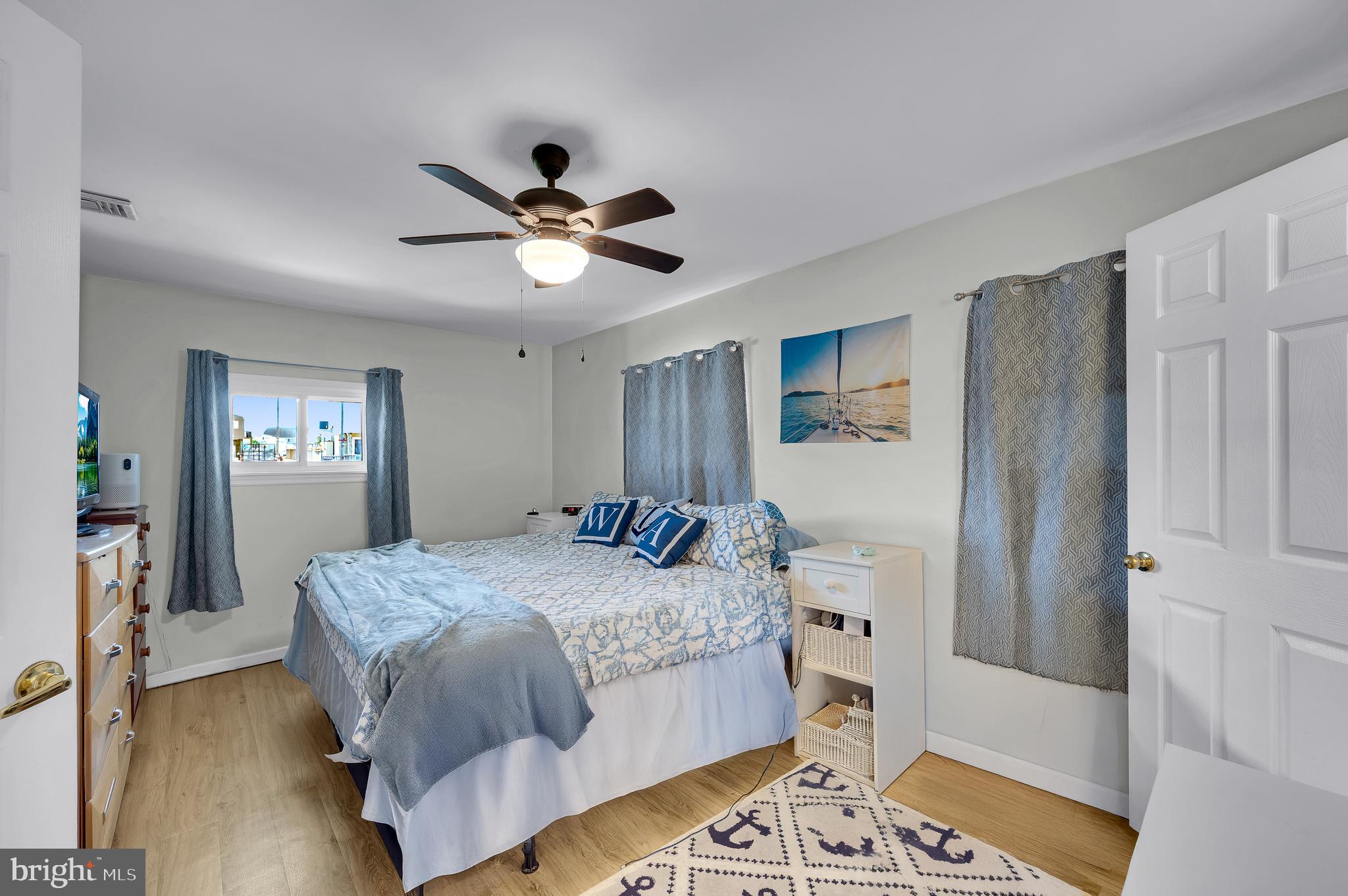 25 West Dory Drive Little Egg Harbor, NJ 08087 - Photo 51 of 56 a bedroom with a bed and a chandelier