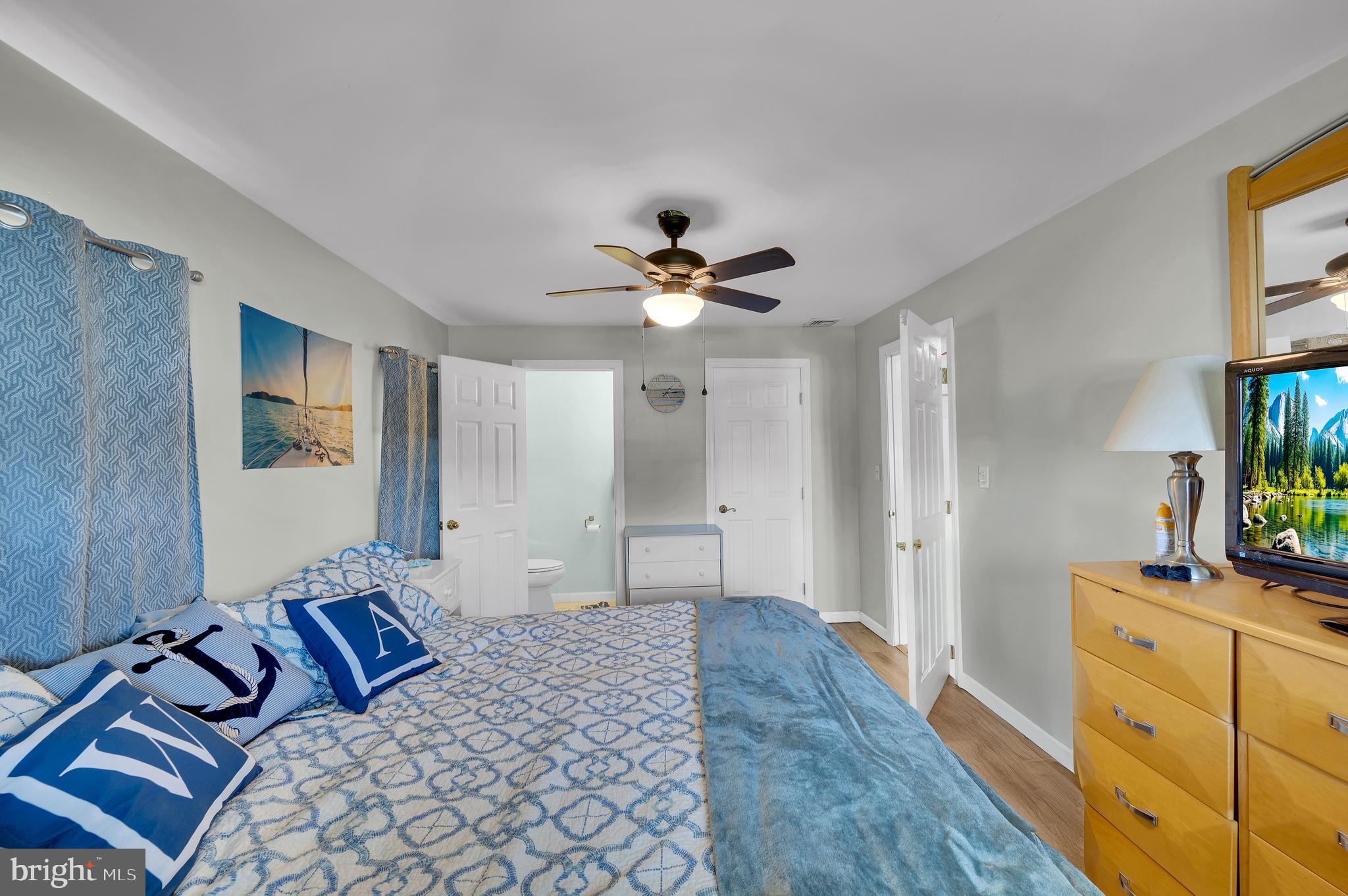 25 West Dory Drive Little Egg Harbor, NJ 08087 - Photo 52 of 56 a bedroom with bed and a chandelier