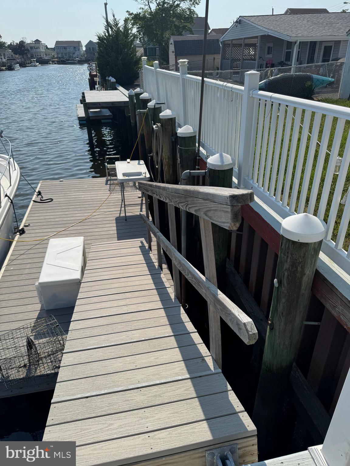 25 West Dory Drive Little Egg Harbor, NJ 08087 - Photo 6 of 56 a balcony with wooden floor table and chairs
