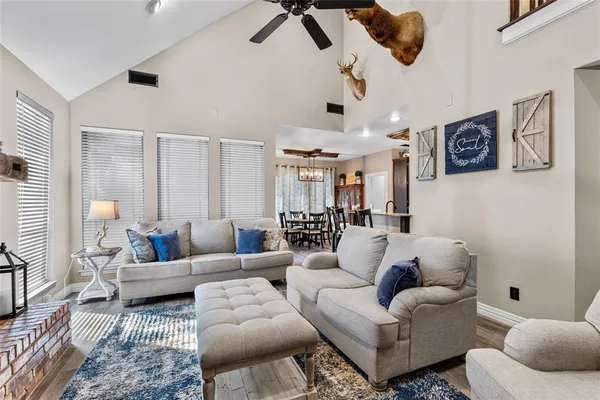 a living room with furniture a flat screen tv and a fireplace