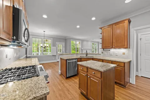 a kitchen with a stove a sink and a microwave