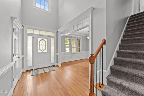 a view of an entryway with wooden floor and door