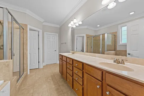 a spacious bathroom with a double vanity sink and a mirror