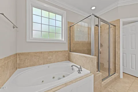a bathroom with a white bath tub and shower