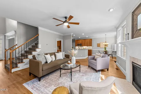 a living room with fireplace furniture and a wooden floor