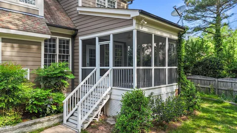 a view of a house with a small deck and a garden