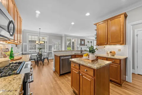 a kitchen with a counter top space a sink appliances and cabinets
