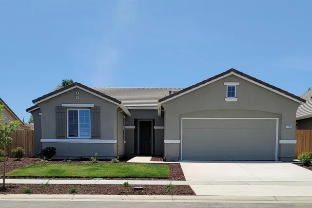 a front view of a house with garage