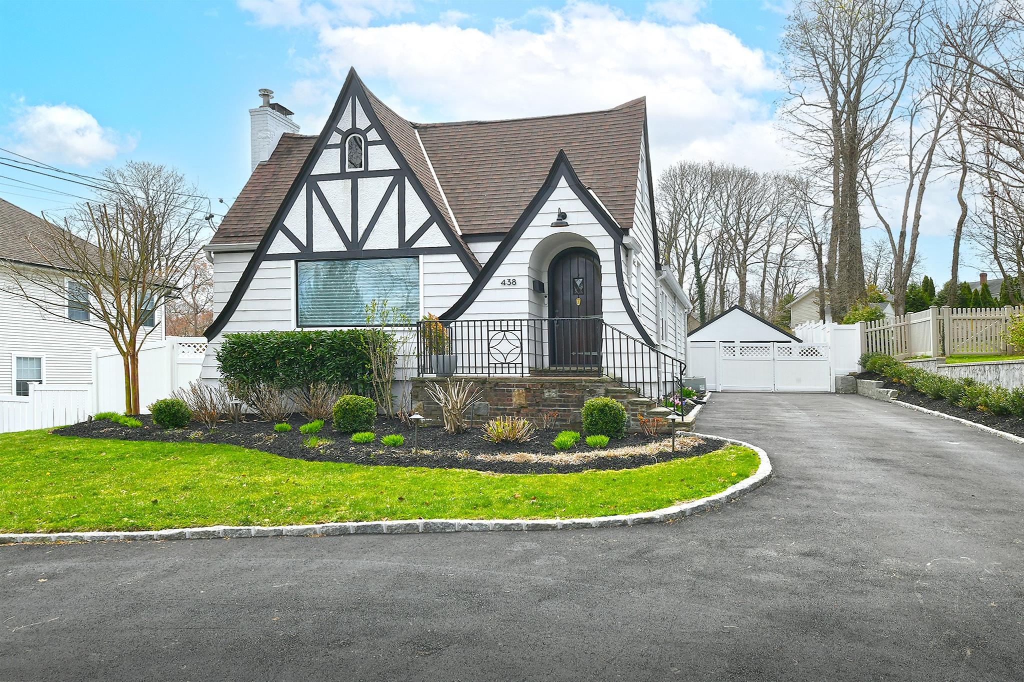 438 Main Street Huntington, NY 11743 - Photo 1 of 1 a front view of a house with a yard and garage