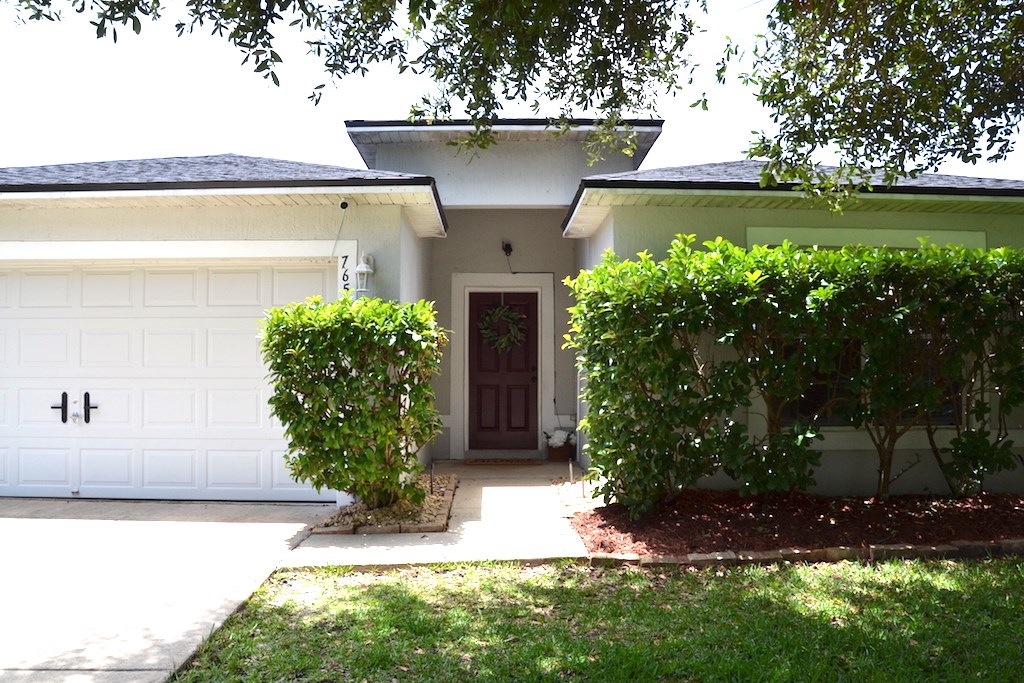 76564 Longleaf Loop Yulee, FL 32097 - Photo 1 of 27 a front view of a house with garden
