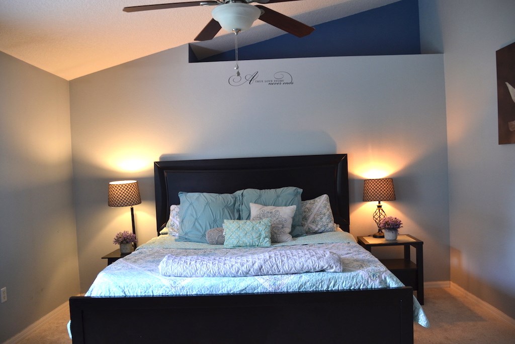 76564 Longleaf Loop Yulee, FL 32097 - Photo 13 of 27 a bedroom with a bed and a lamp